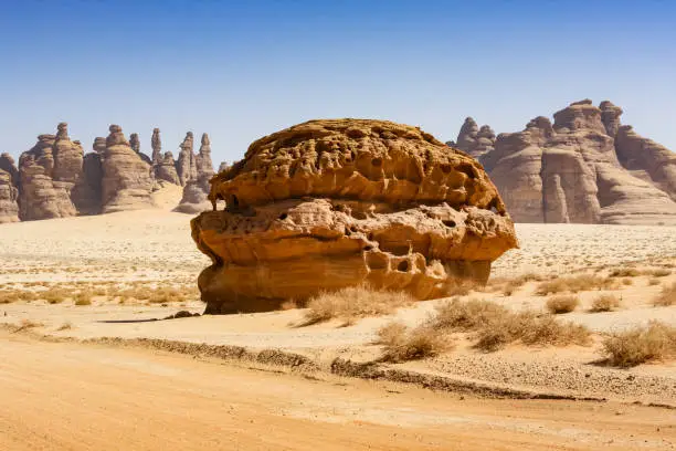 Stock photograph of rock formations at Mada'in Saleh near Al Ula, Saudi Arabia on a sunny day.