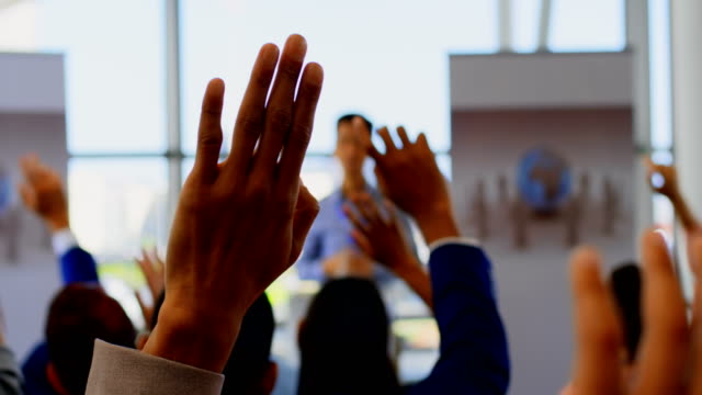 Business people raising their hands in the business seminar 4k