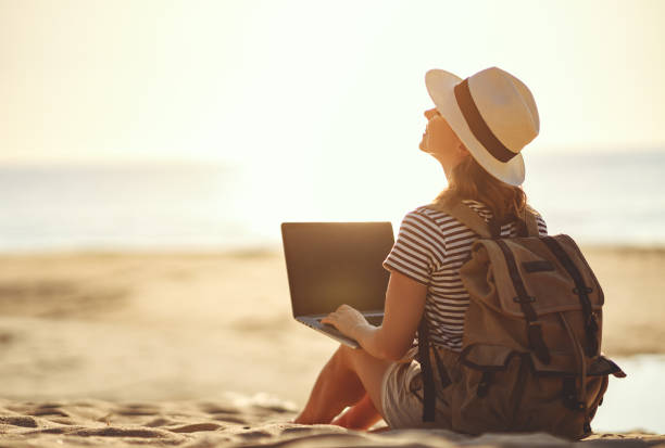 istock young woman working with laptop on nature in beach 1138494678