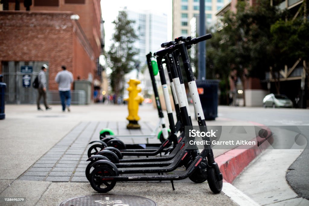 Electric Scooters For Rent Electric scooters in a city available for rent Electric Push Scooter Stock Photo