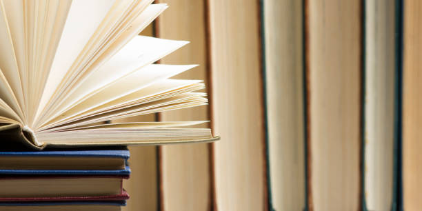 istock Open book, hardback books on wooden table. Back to school. Copy space. 1138499229