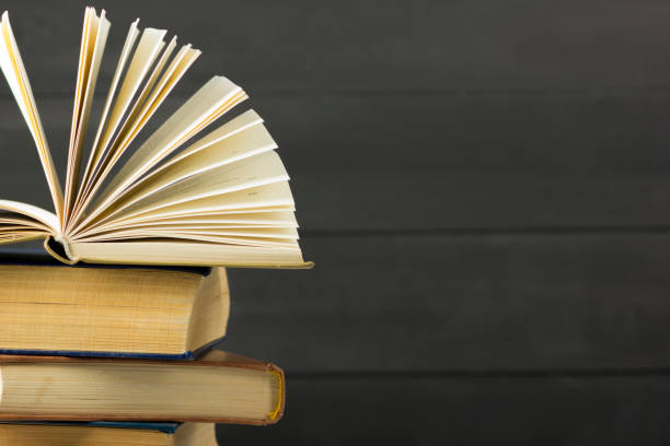 istock Open book, hardback books on wooden table. Back to school. Copy space. 1138499244