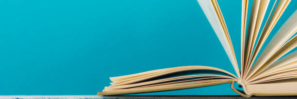 istock Open book, hardback books on wooden table. Back to school. Copy space. 1138499258