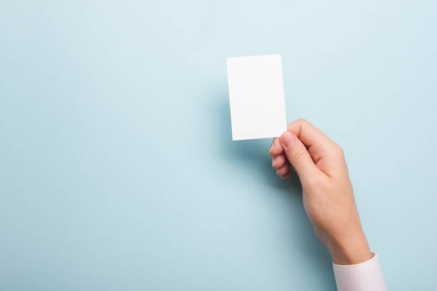 istock Hand holding white business card on white background 1138499869