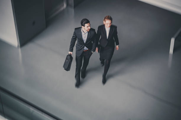 istock Business Colleague Talking As They Walk Through Office Lobby 1138500133