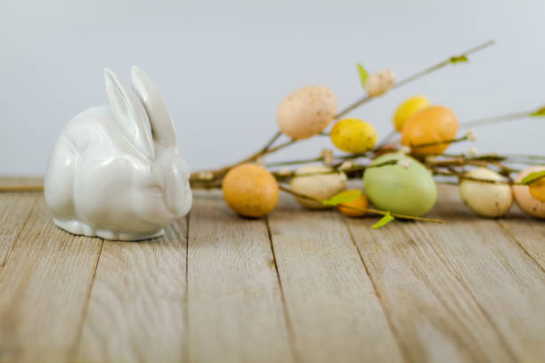 istock Easter Spring background on wooden board with white rabbit and flowers 1138501143