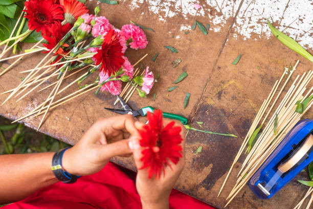 istock Florist worktable. Florist at work creating bouquet at flower shop. Top view. 1138501852