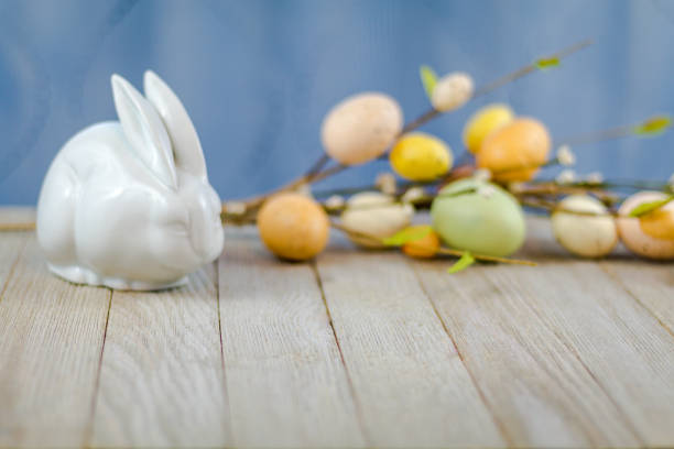 istock Easter Spring background on wooden board with white rabbit and flowers 1138501861