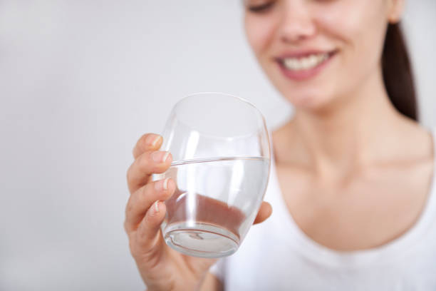 istock Young woman drinking water 1138504093