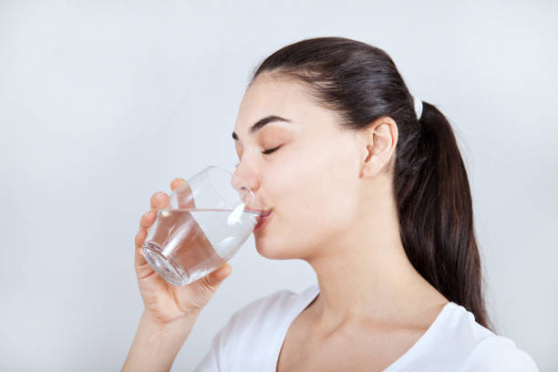 istock Young woman drinking water 1138504482
