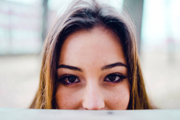 Woman peeks through the neighbours fence