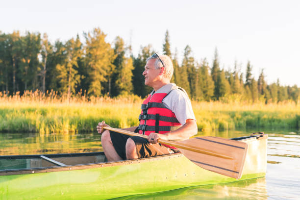 istock Senior man canoeing on a beautiful Idaho lake 1138505009