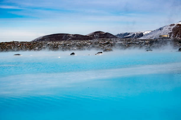 istock Still blue geothermal water reflecting clouds, snow and volcanic rock 1138506324