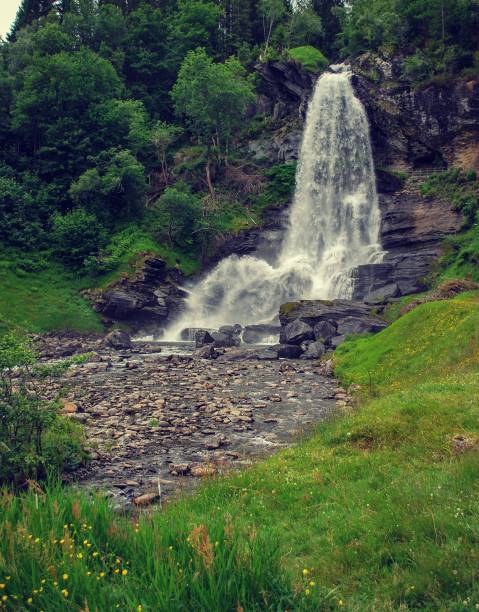 istock Waterfall in Norway with jagged rocks and pebble foot path 1138508990