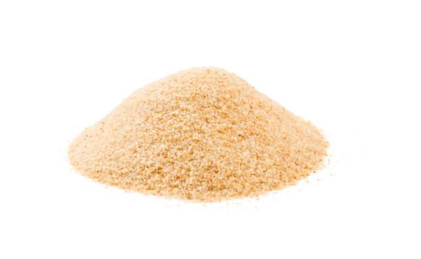 dried milled ground garlic heap isolated on white background. front view
