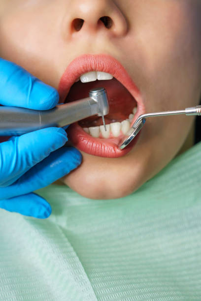 istock Dentist treats girl's teeth. 1138516521