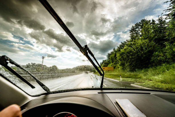 driving a rainy highway Driving through a rainy highway windshield wiper photos stock pictures, royalty-free photos & images