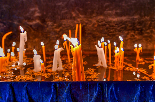 Lit candles burning in old Sevanavank church in Sevan,  Armenia.
