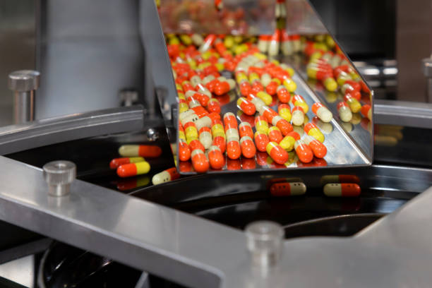 pharmacy medicine capsule pill in production line at medical factory. selective focus. pharmacy medicine capsule pill in production line at medical factory. selective focus. pharmaceutical factory photos stock pictures, royalty-free photos & images