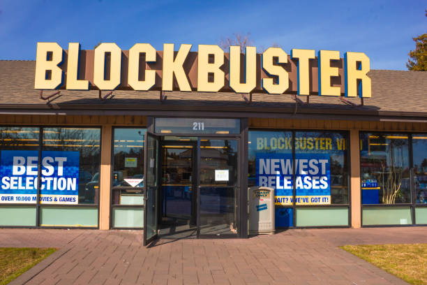 Oregon, USA 3/25/2019: The last Blockbuster store in the USA. The store is shown in the inside and also on the outside from the parking lot. Blockbuster LLC, formerly Blockbuster Entertainment, Inc.,and also known as Blockbuster Video or simply Blockbuster, was an American-based provider of home movie and video game rental services through a video rental shop, DVD-by-mail, streaming, video on demand, and cinema theater. Blockbuster expanded internationally throughout the 1990s. At its peak in 2004, Blockbuster employed 84,300 people worldwide, including about 58,500 in the United States and about 25,800 in other countries, and had 9,094 stores in total, with more than 4,500 of these in the US.