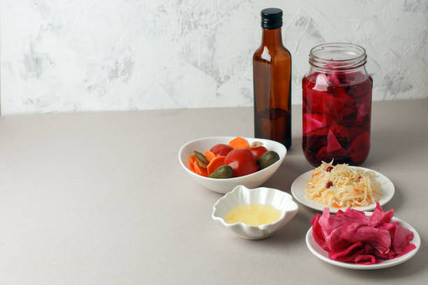 istock Fermented vegetables on plate on gray background: sauerkraut, pickled cabbage with beetroot, pickled cucumbers, carrots and tomatoes. Vegetarian food concept 1138531092