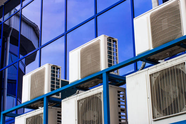 istock Wall of a large office building with blue windows and air conditioning 1138532304