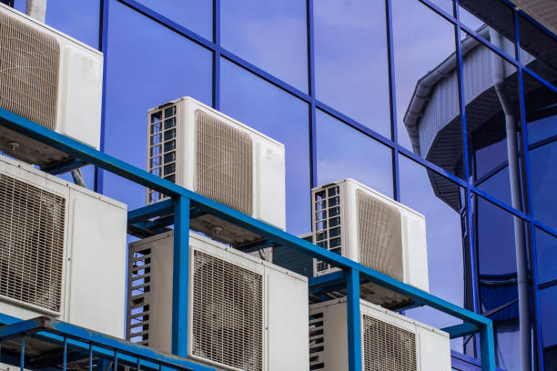 Wall of a large office building with blue windows and air conditioning