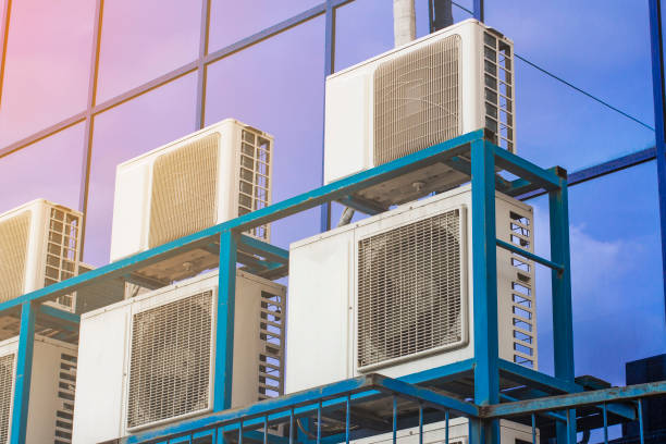 istock Wall of a large office building with blue windows and air conditioning 1138532311
