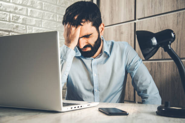 istock man hand in head on office desk 1138532395