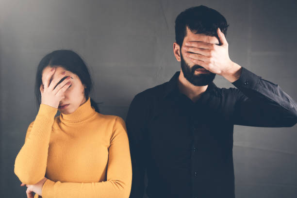 istock sad couple hand in face 1138532480