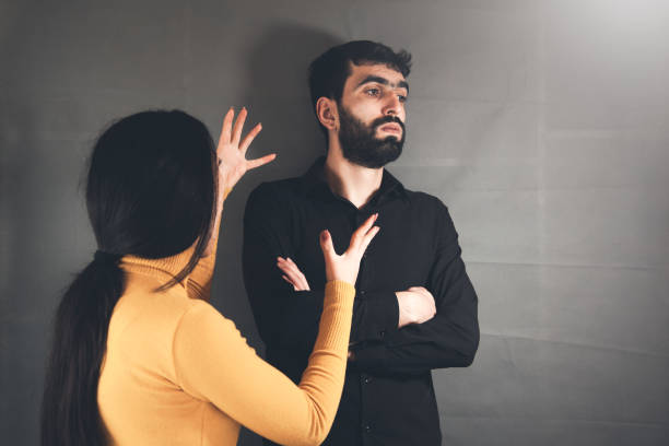 istock angry woman and man on dark background 1138532481