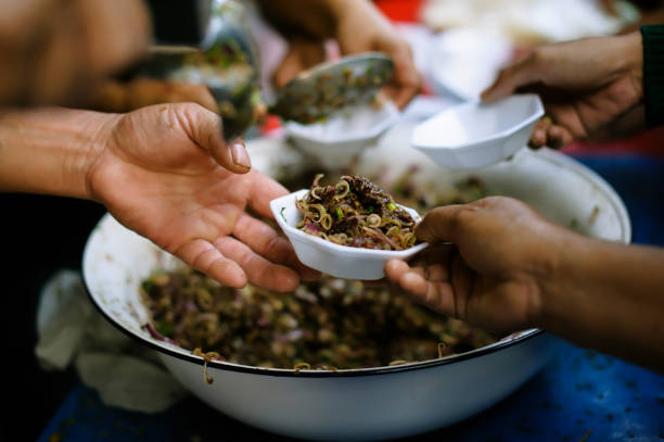 istock Charity food : Feeding the poor to hands of a beggar. Poverty concept 1138534186