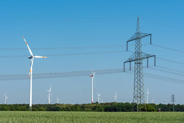 istock Overhead power line and wind turbines 1138535061