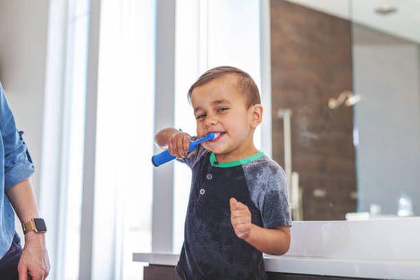 istock Mother with Boys Brushing Teeth Active At Home Experiencing Quality Life Practicing Good Hygiene 1138536442