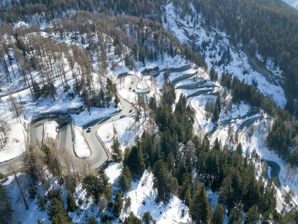 Aerial view of the famous curvy Maloja pass in winter, Switzerland Aerial view of the famous curvy Maloja pass in winter, Switzerland maloja region stock pictures, royalty-free photos & images