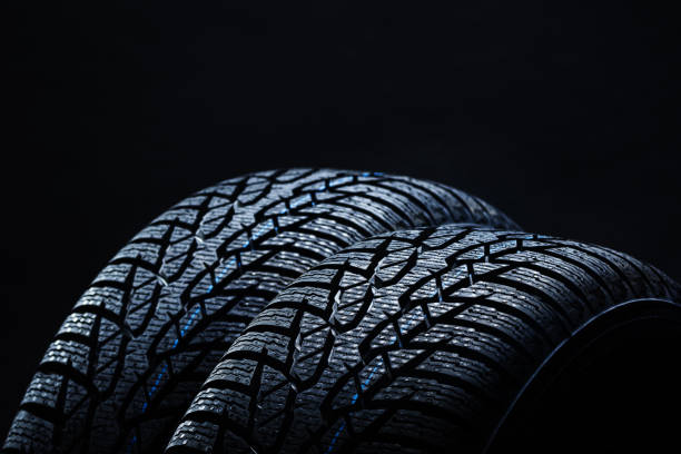 istock Winter tyres on black background with contrasty lighting 1138540297