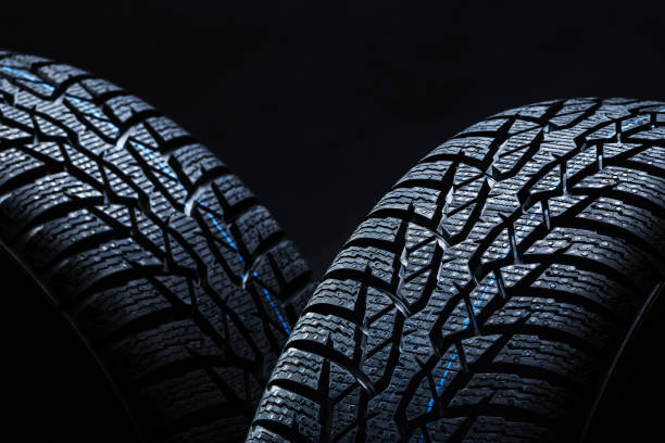 istock Winter tyres on black background with contrasty lighting 1138540301