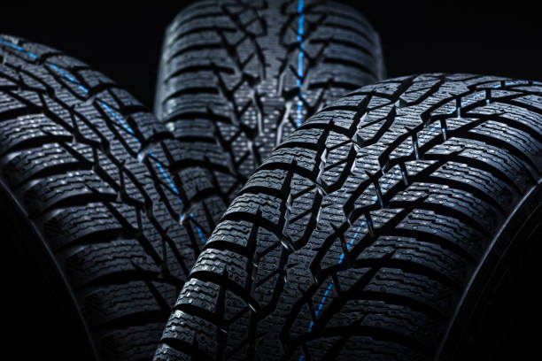 istock Winter tyres on black background with contrasty lighting 1138540305