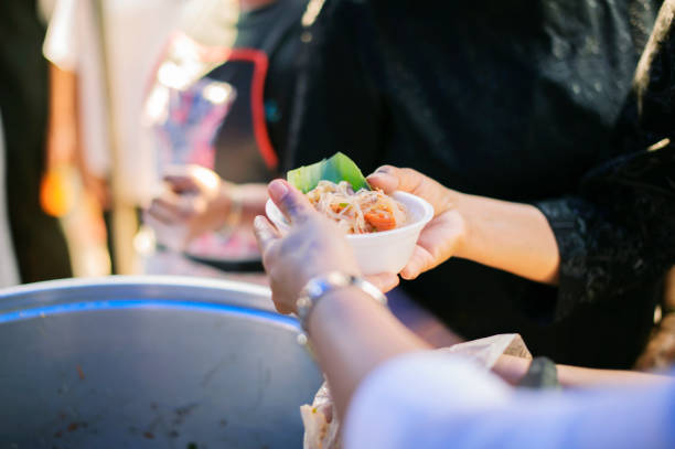 istock Starvation concept : Rich people give food to the poor. 1138541366