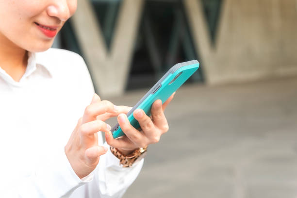 istock business woman using smart phone city 1138541534