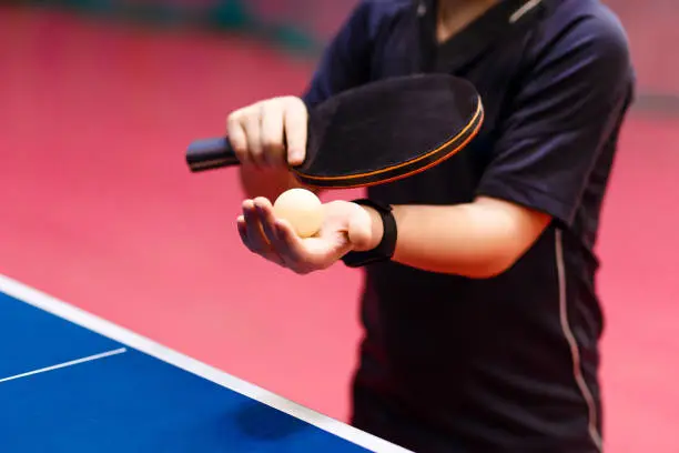 serve the ball in table tennis close, fitness bracelet on the hand
