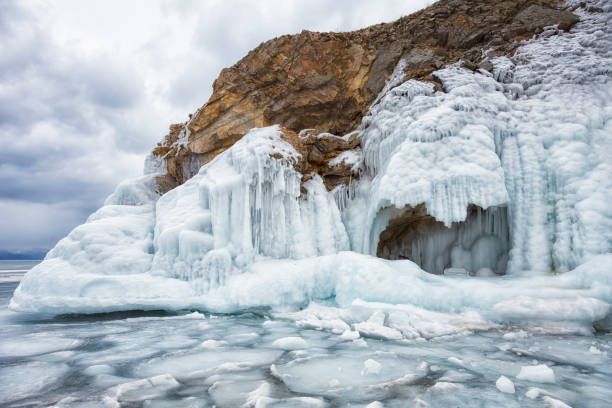 istock Icicles hanging from rocky cliffs in frozen Baikal lake 1138546990