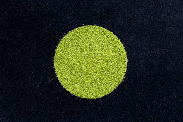 matcha green tea powder on black slate background