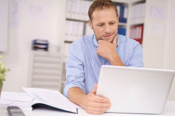 istock Handsome businessman working on his laptop 1138551386