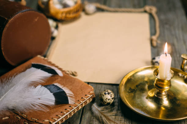 istock Vintage mock up. Closeup brass candlestick with burning candle, vintage objects and yellow paper for your text on wood board. 1138553539