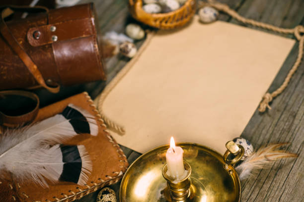 istock Closeup candlestick with burning candle, quail eggs, yellow paper for text on rustic wood board. 1138554136