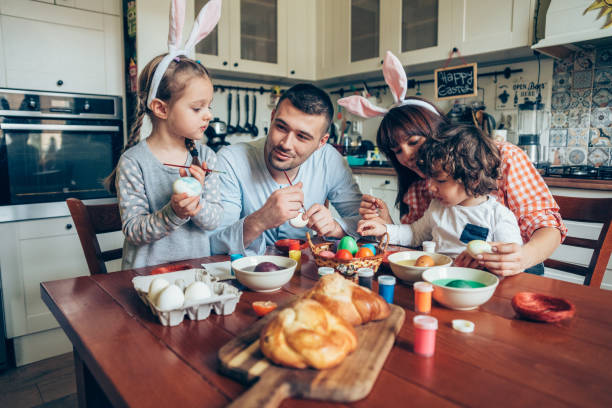 istock Happy family painting Easter eggs 1138555517