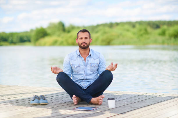 istock Modern businessman in casual clothes with digital tablet meditating 1138556601