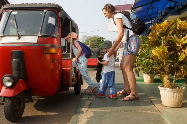 Family on vacation, mother and kids getting in a tuk-tuk, having fun. Family on vacation, mother and kids getting in a tuk-tuk, having fun. Travelling with children, backpacking, family time, active lifestyle concept. taxi sri lanka stock pictures, royalty-free photos & images