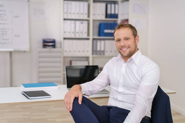 Relaxed business manager with a friendly smile stock photo